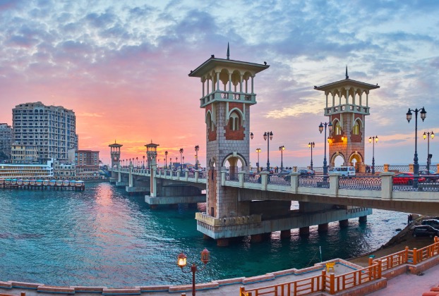 Scenic sunset view over a bridge and water.