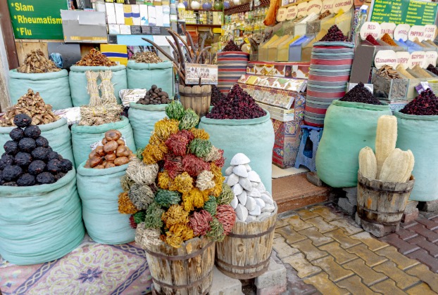 Colorful spices and herbs displayed in large sacks.
