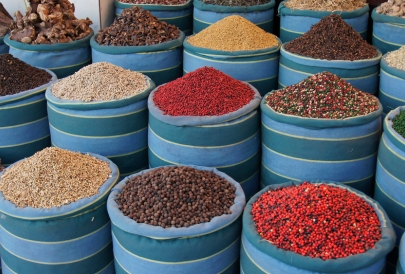 Variety of spices in colorful market bins.