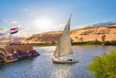 Sailboat on river with desert background